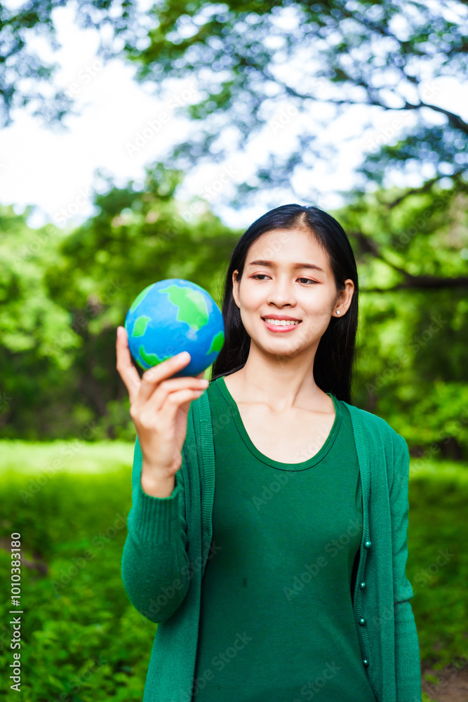An Asian woman holds a globe in a green forest,symbolizing the importance of preserving nature.emphasizes balance between humans, natural resources,sustainable environmental development protect An Asian woman holds a globe in a green forest,symbolizing the importance of preserving nature.emphasizes balance between humans, natural resources,sustainable environmental development protect