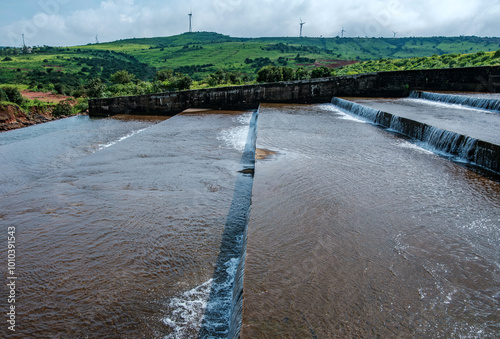 Water flows down the Jagmin step dam near Satara India at the end of the monsoons. Monsoon is the annual rainy season in India from June to September. photo