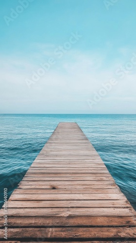 A pier extending into an empty ocean, minimalist and calm. 