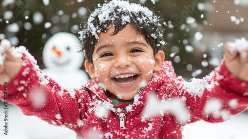 Hispanic little boy with arms outstretched playing snow outside