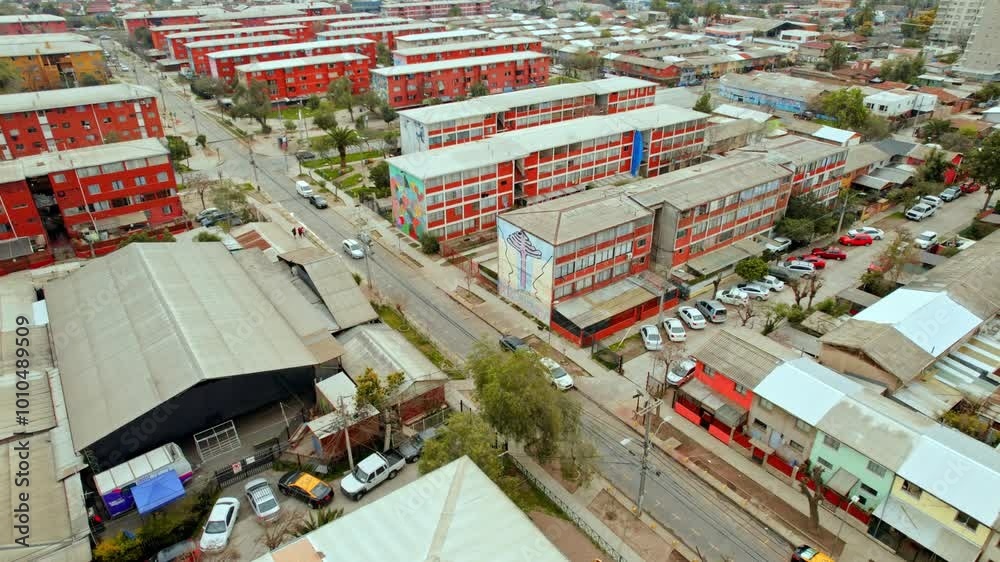 Aerial orbit establishing over the residential blocks with murals of the open air museum of San Miguel, Santiago de Chile.
