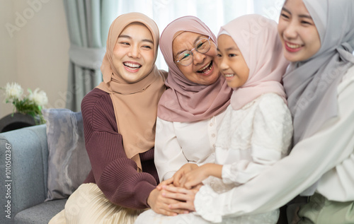 Four generations of muslim woman in hijab enjoying family time showing love, joy and happiness, grandmother, mother, daughters and granddaughter celebrating family traditions, togetherness and support