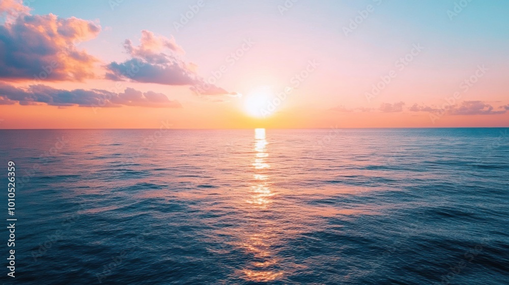 Obraz premium Sunset over a calm sea with no visible land.