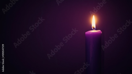 A Single Purple Candle Burning Brightly Against a Dark Background