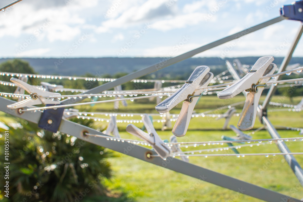 Wet weather concept image with clothes pegs on a washing line dripping wet. Laundry and drying concept. No tumble drier and wet clothes.
Difficulty in drying clothes. English weather. Wet weather concept image with clothes pegs on a washing line dripping wet. Laundry and drying concept. No tumble drier and wet clothes.
Difficulty in drying clothes. English weather.