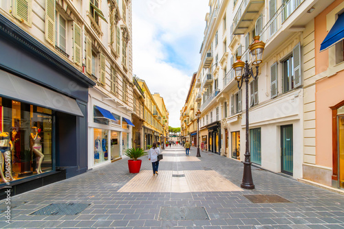 Fototapeta Naklejka Na Ścianę i Meble -  A street of luxury boutiques and shops leading to the Promenade des Anglais along the French Riviera Cote d'Azur, at Nice, France.