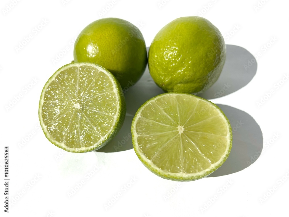 Sliced lime isolated on white background. Fresh limes with shadow. Sliced lime isolated on white background. Fresh limes with shadow.
