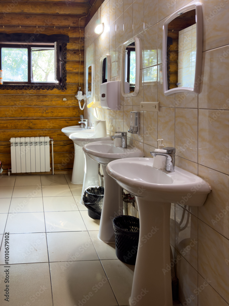 Fotografie A bathroom with three sinks and a mirror