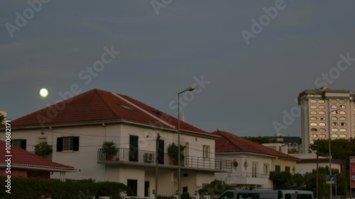 A full monn shining behind a town villa in Costa Da Caparica. photo