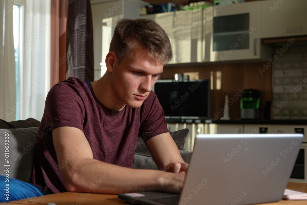 Relaxing at home, a young man immerses himself in an online poker tournament, surrounded by poker chips while focusing intently on his laptop screen. Relaxing at home, a young man immerses himself in an online poker tournament, surrounded by poker chips while focusing intently on his laptop screen.