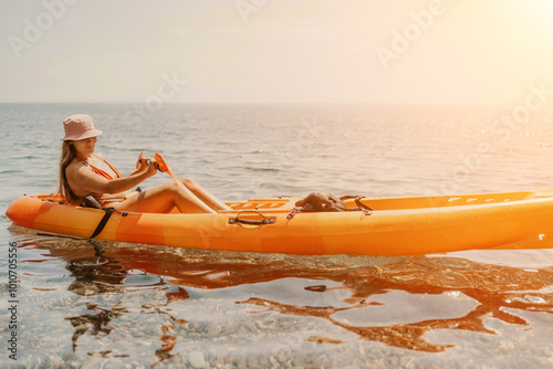 Kayak sea woman. Happy attractive woman with long hair in red swimsuit, swimming on kayak. Summer holiday vacation and travel concept.