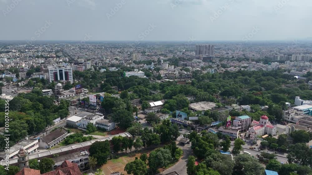 An expansive aerial view of Vijayawada city, showing the integration of urban structures with the natural hill in the background. An expansive aerial view of Vijayawada city, showing the integration of urban structures with the natural hill in the background.