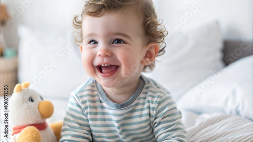 Toddler Smiling on Bed with Toy, Portrait of a Happy Baby