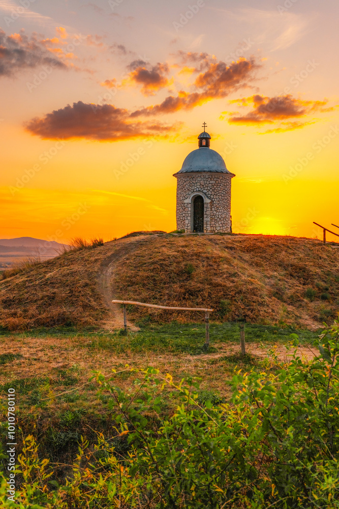 Chapel Hradistek near Velke Bilovice Czech Republic. Vineyard rows in bright sunlight, nestled between hills and trees. Moravia wine landscape. Chapel Hradistek near Velke Bilovice Czech Republic. Vineyard rows in bright sunlight, nestled between hills and trees. Moravia wine landscape.