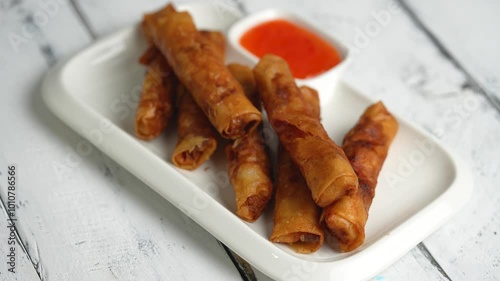 Filipino most favorite food, ground marinated pork meat wrapped in rice wrapper and serve with sweet and sour sauce, also known as lumpiang shanghai