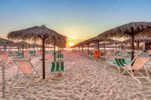 Obraz na płótnie Captivating sunset at Silvi Marina beach on the Adriatic coast of Italy with colorful beach chairs and scenic views, coast of the Abruzzo region. w salonie