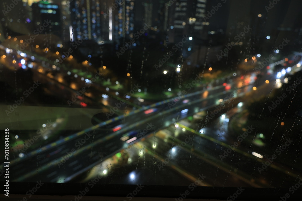Raindrops on glass with vehicle lights as background using long exposure method. abstract background with vehicle lights. Raindrops on glass with vehicle lights as background using long exposure method. abstract background with vehicle lights.