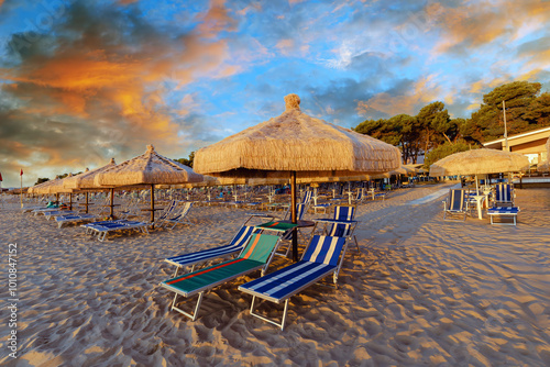 Fototapeta Naklejka Na Ścianę i Meble -  Captivating sunset at Silvi Marina beach on the Adriatic coast of Italy with colorful beach chairs and scenic views, coast of the Abruzzo region.