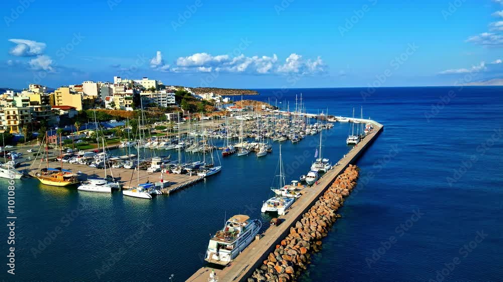 Aerial view port and coastal city of Agios Nikolaos in Crete Island, Greece Blue Summer Coastline Aerial view port and coastal city of Agios Nikolaos in Crete Island, Greece Blue Summer Coastline