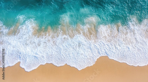 Top-down view of crystal-clear ocean waves lapping against a pristine Vietnam beach, creating a peaceful and beautiful natural background.