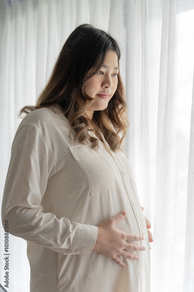 Pregnant asian woman holds hands on belly touching her baby caring about her health Beautiful happy pregnant woman tender mood photo of pregnancy Pregnant asian woman holds hands on belly touching her baby caring about her health Beautiful happy pregnant woman tender mood photo of pregnancy