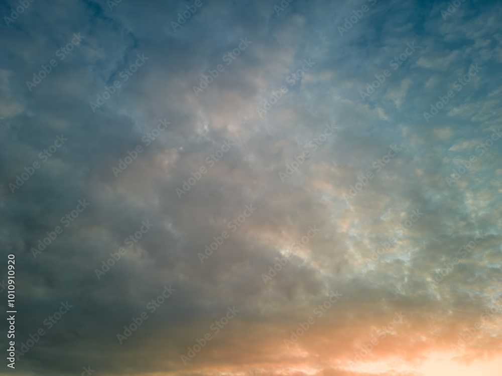 The rays of the sun breaking through the dramatic clouds in the evening or in the morning in the sunset or sunrise sky. The rays of the sun breaking through the dramatic clouds in the evening or in the morning in the sunset or sunrise sky.