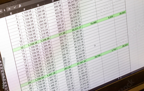 Shot of an dark mode excel sheet on computer screen showing bank loan amortization table. Banking