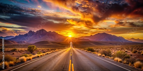 A tranquil desert highway stretches under a sunset sky, with mountains softly illuminated by warm light, creating a serene atmosphere filled with quiet beauty.