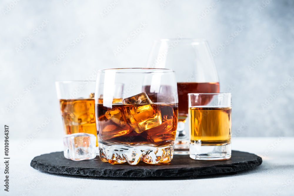 Strong alcohol drink set at light background. Cognac, whisky and rum.