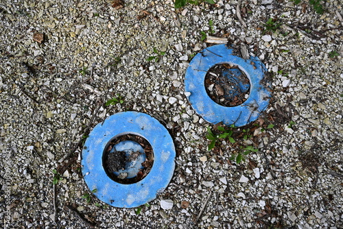 Blue mains water stopcocks located by the road in a French village