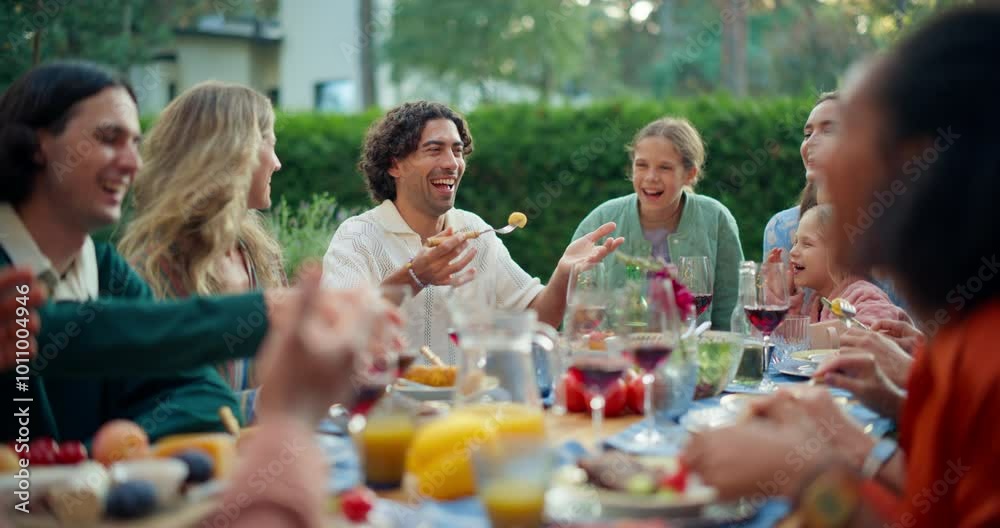 Parents, Children, Relatives and Friends Having an Open Air Barbecue Dinner in Their Backyard. Old and Young People Talk, Chat, Have Fun, Eat and Drink. Garden Party Celebrations on a Warm Day Parents, Children, Relatives and Friends Having an Open Air Barbecue Dinner in Their Backyard. Old and Young People Talk, Chat, Have Fun, Eat and Drink. Garden Party Celebrations on a Warm Day