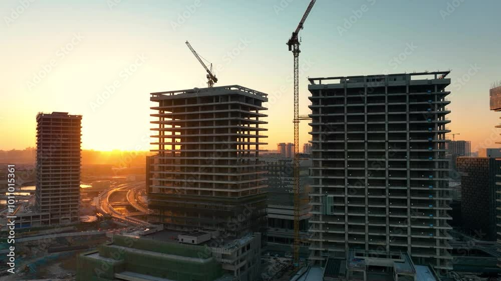 Aerial view construction crane in a construction site at sunset