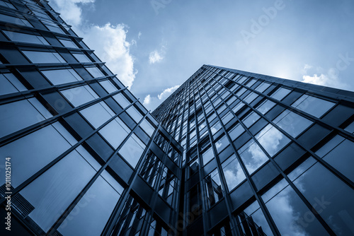 Dramatic Low-Angle View of Contemporary Skyscraper Against Cloudy Sky