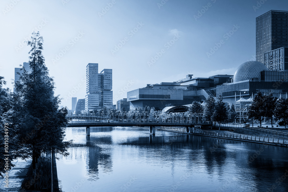 Naklejka premium Serene Urban Waterfront with Modern Architecture and Reflections