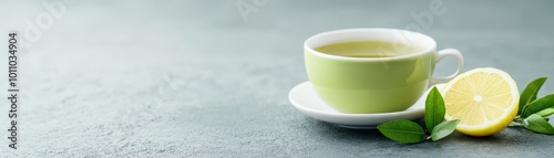 A serene image of a green tea cup paired with a slice of lemon on a textured surface, perfect for wellness, food blogs, or lifestyle articles about healthy living and culinary experiences,