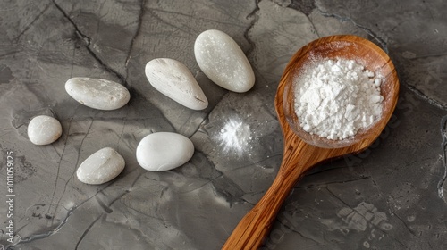 smooth stones and a wooden spoon for scooping the powders photo