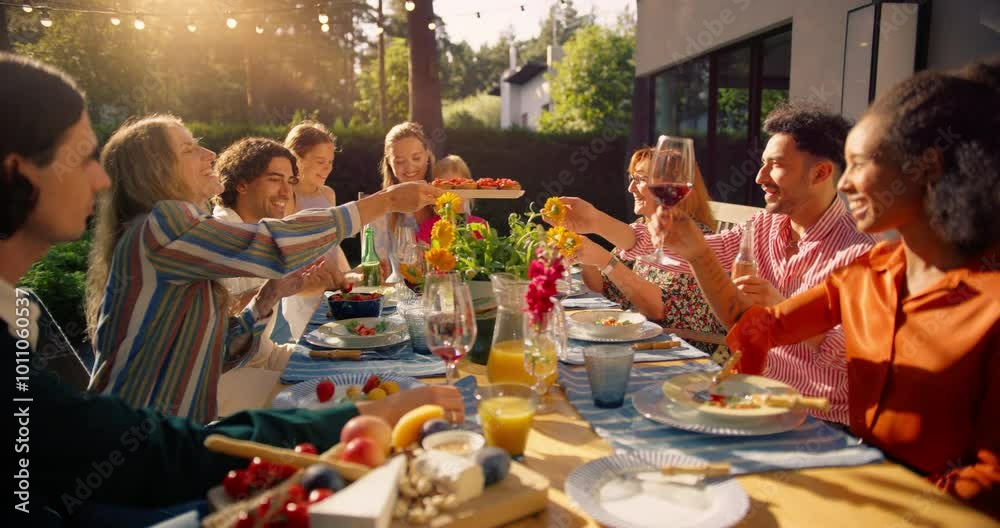 Family and Multiethnic Diverse Friends Gathering Together at a Backyard Party Table at Sunset. People Eating Meat From a Fire Grill, Sharing Tasty Salads at a Big Family Celebration with Relatives