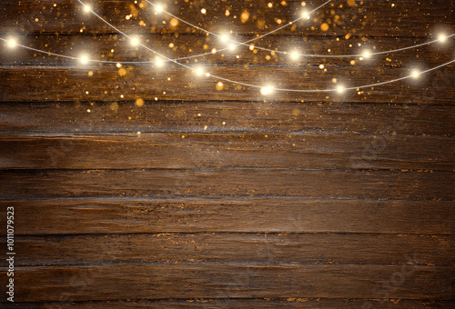 Christmas background with copy space. Top view of an empty rustic wooden table with string lights and bokeh