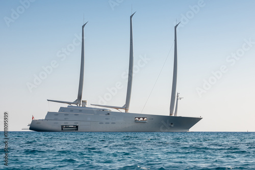 Modern three mast Superyacht sailing on calm Mediterranean Sea at day