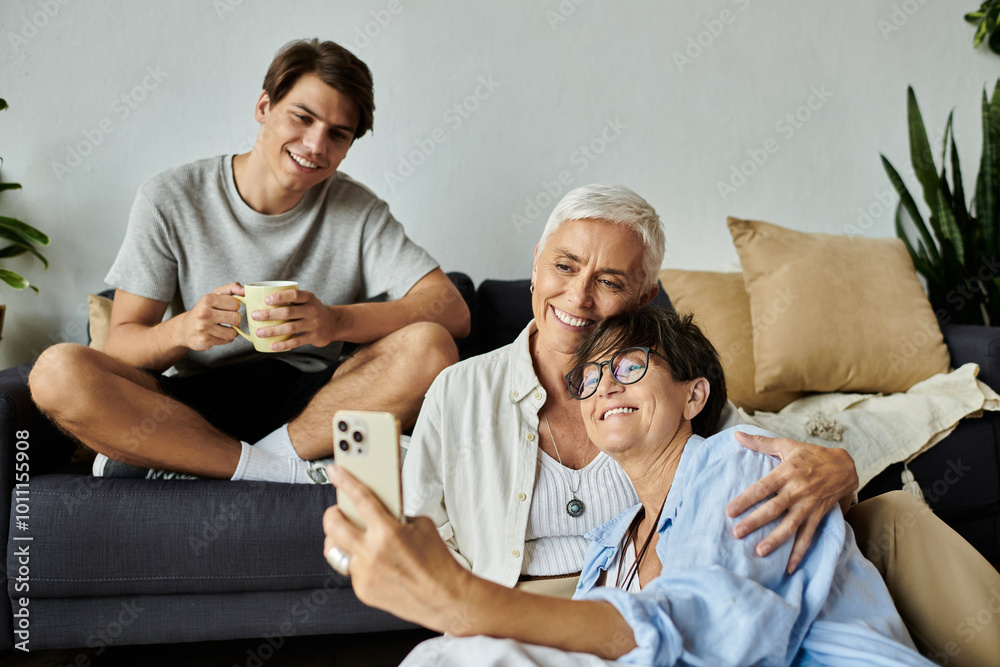 Fototapeta premium Three family members share laughter and joy while capturing a fun moment together.