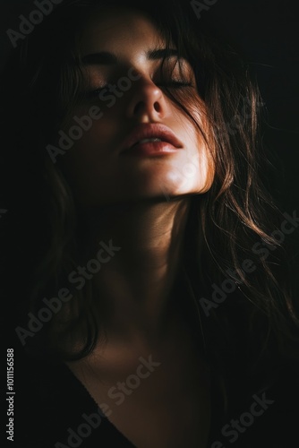 Woman with eyes closed in darkness