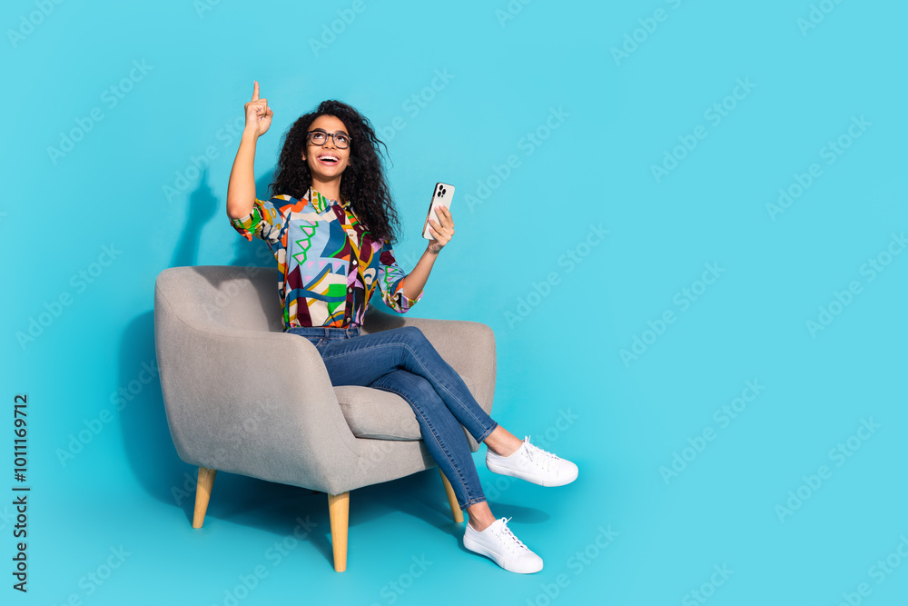 Photo of attractive cute nice woman wear stylish print clothes recommend empty space isolated on blue color background Photo of attractive cute nice woman wear stylish print clothes recommend empty space isolated on blue color background