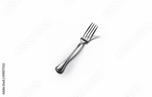 A silver fork lies on a white background.