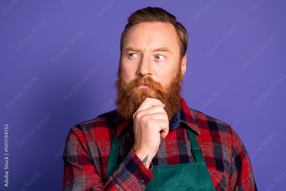 Photo of thoughtful man gardener wear red plaid shirt green apron look empty space isolated on purple color background Photo of thoughtful man gardener wear red plaid shirt green apron look empty space isolated on purple color background