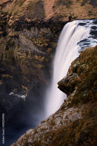 Skogafoss waterfall in winter under a cloudy sky