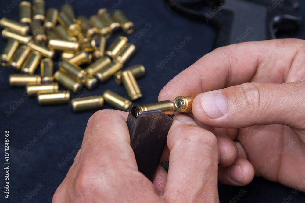 Fototapeta premium Man's hand holding bullet shells on a dark background