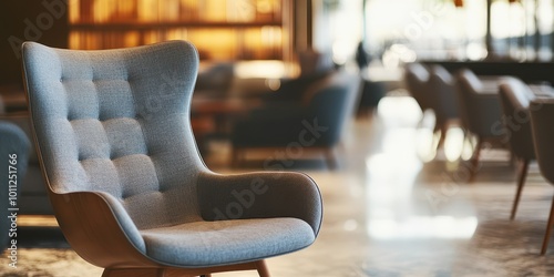 Stylish grey armchair in a modern cafe, perfect for relaxing or reading in a cozy atmosphere with soft lighting. photo