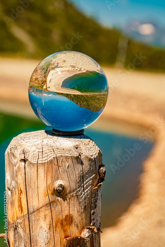 Crystal ball alpine summer landscape shot with a lake at the famous Mount Goldried, Matrei, Eastern Tyrol, Austria photo