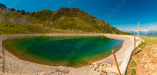 High resolution stitched alpine summer panorama with reflections in a lake at Mount Goldried, Matrei, Eastern Tyrol, Austria photo