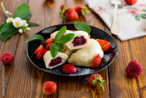 cooked sweet homemade steamed dumplings with strawberries